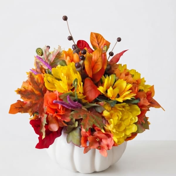 Autumn floral arrangement in a white pumpkin vase
