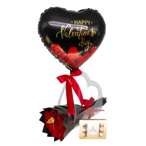 Heart balloon above a bouquet of red roses with a box of chocolates