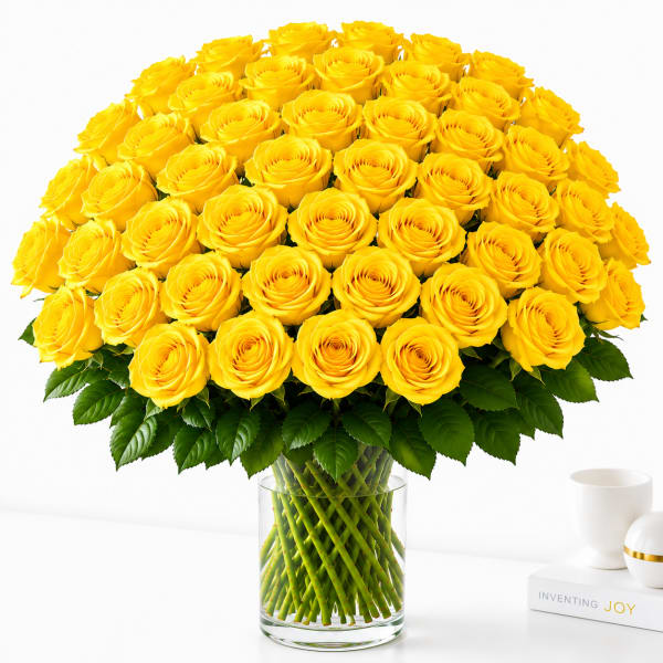 Large bouquet of yellow roses in a clear glass vase