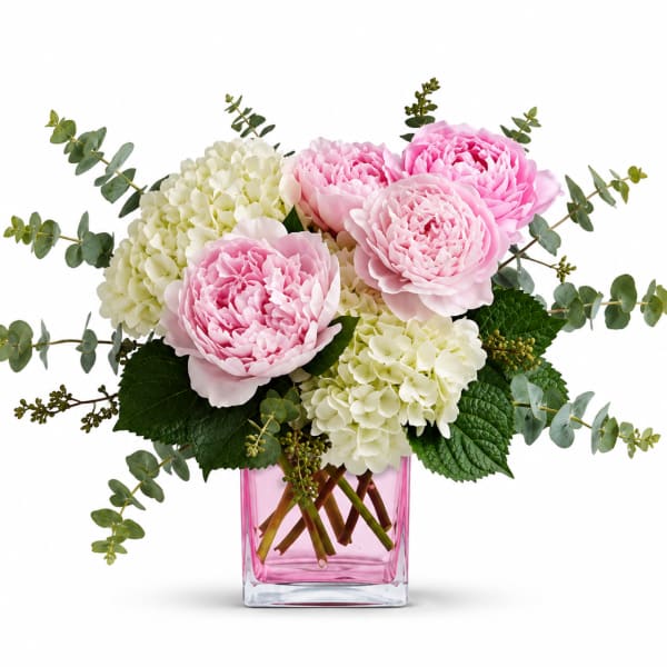 Pink peonies and white hydrangeas in a pink glass vase