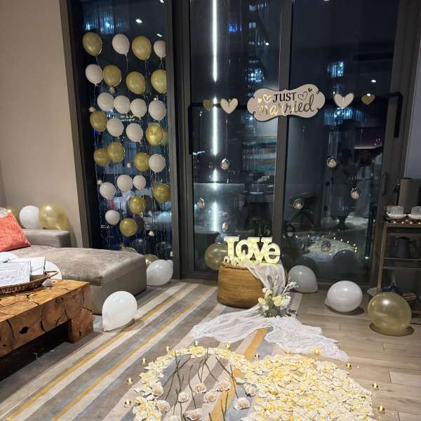 Wedding floor display with white and gold balloons and flower petals