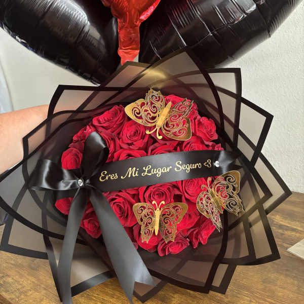 Red rose bouquet with black wrapping and heart balloons