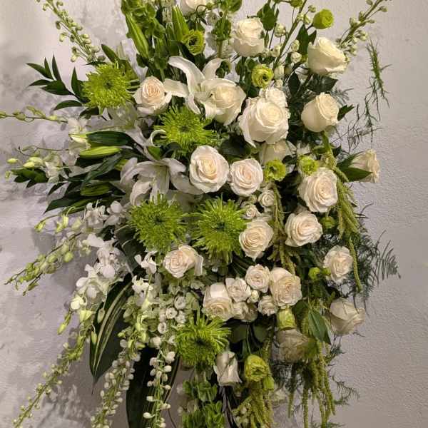 Tall white and green floral spray on an easel
