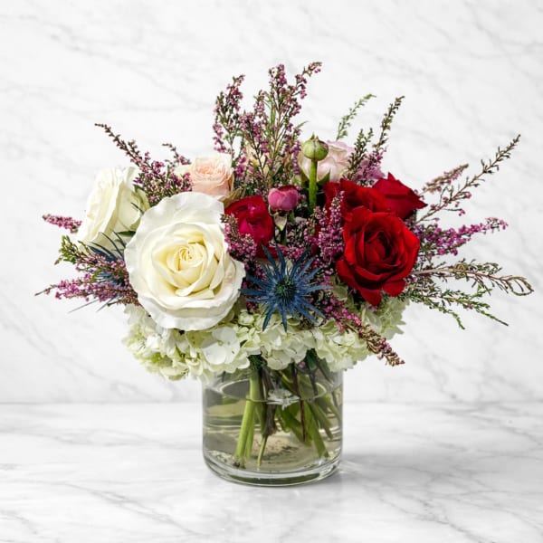 Bouquet of red and white roses in a glass vase