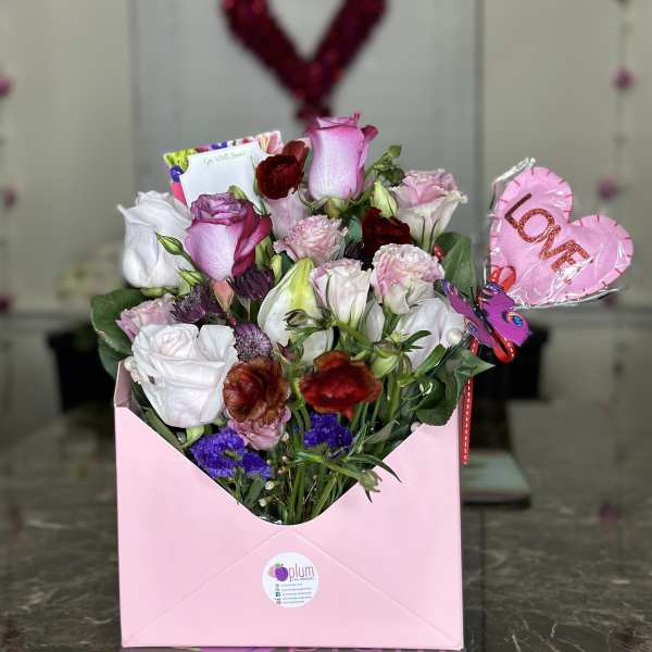 Pink and white rose bouquet in a pink gift box with a heart balloon