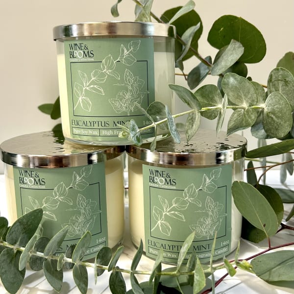 Three eucalyptus mint candles with eucalyptus branches