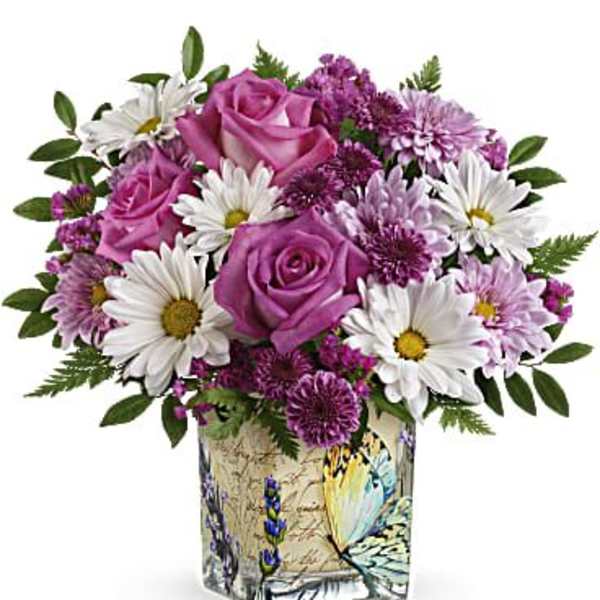 Pink roses and white daisies in a decorative square vase