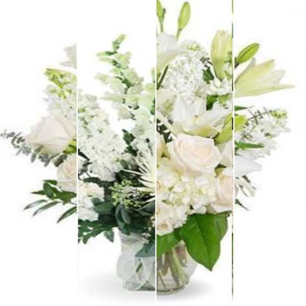 White floral arrangement with lilies and roses in a glass vase