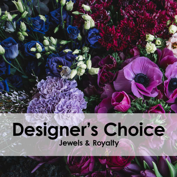 Mixed bouquet of purple, blue, and pink flowers with a text banner