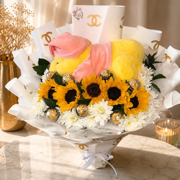 Sunflower bouquet with white daisies and a yellow plush bear