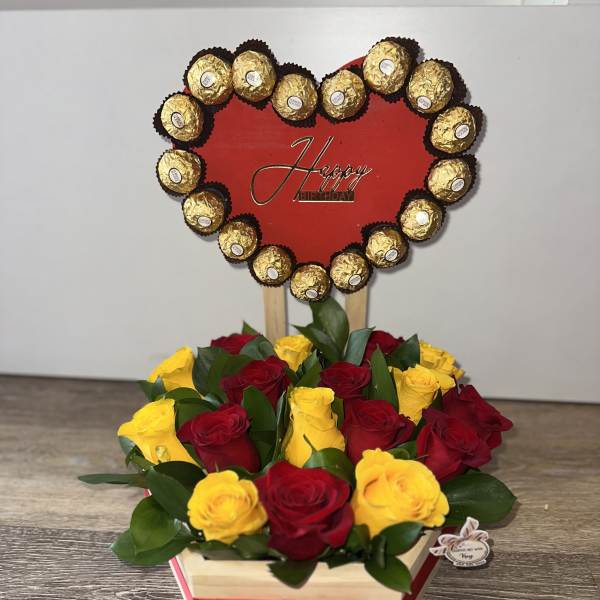 Beautiful wooden base with a heart on top, bordered with Ferrero Rocher chocolates, and filled with yellow and pink roses underneath