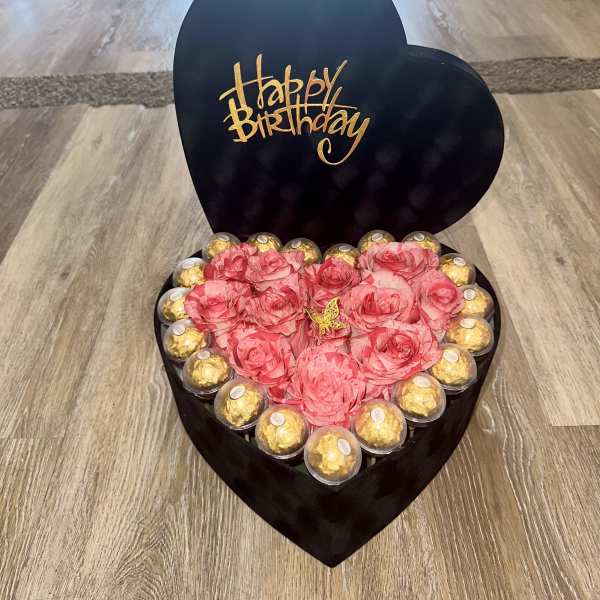 Heart-shaped birthday gift box with pink roses and gold chocolates