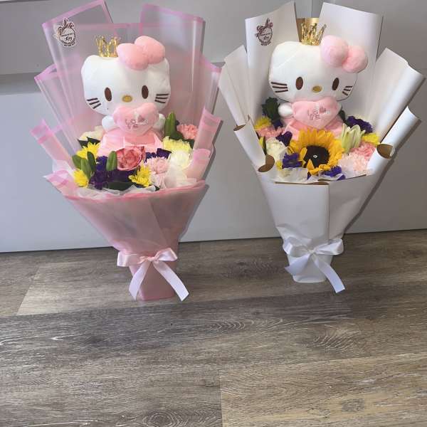 Two bouquet gifts with Hello Kitty plush toys and mixed flowers in pink and white wrap.