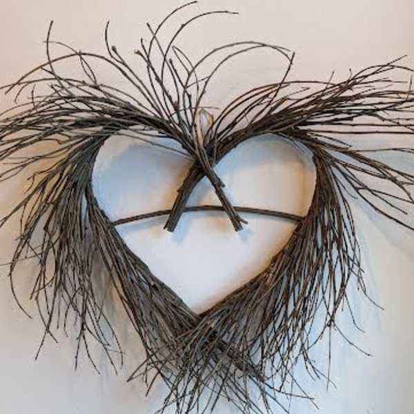 Heart-shaped twig wall hanging with wispy branches at the top