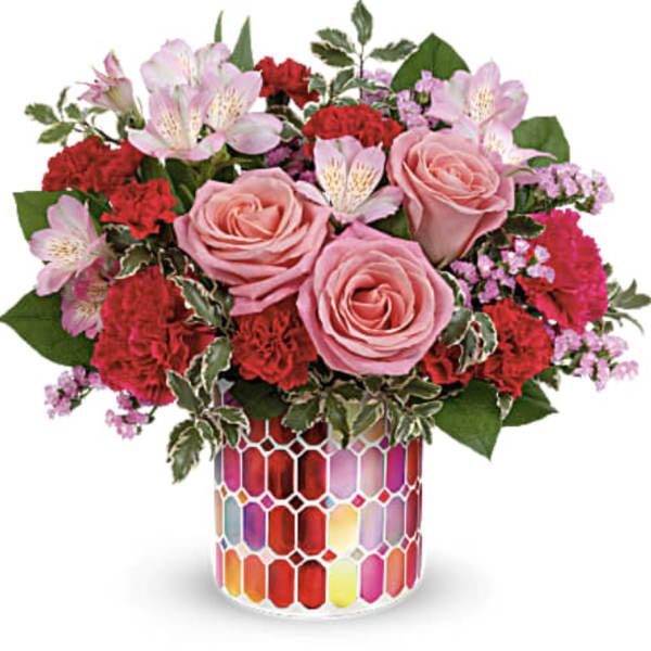 Pink roses and red carnations in a colorful mosaic vase