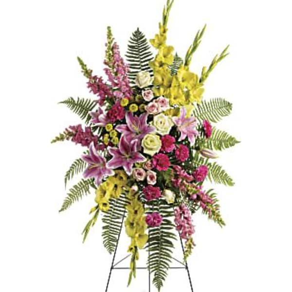 Standing floral spray with pink, yellow, and white flowers on an easel
