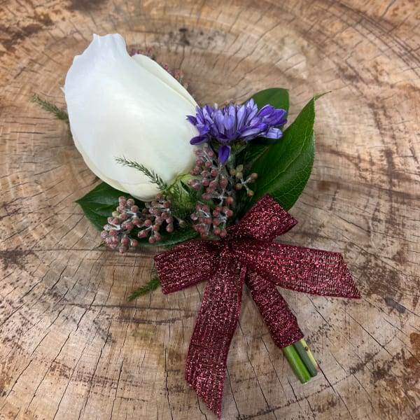White rose boutonniere with purple accent flower and burgundy ribbon