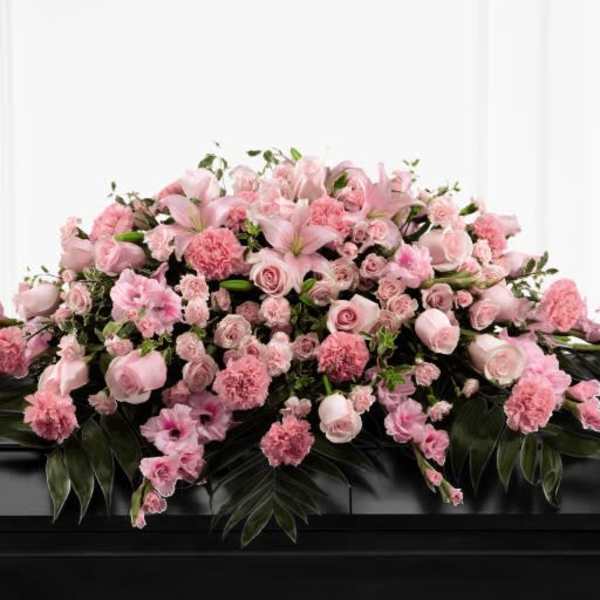 Pink floral casket spray with roses and carnations