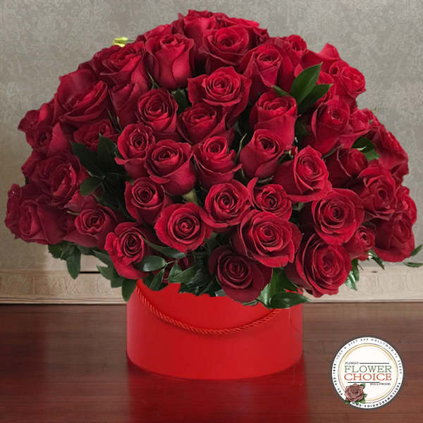 Red roses arranged in a red round box
