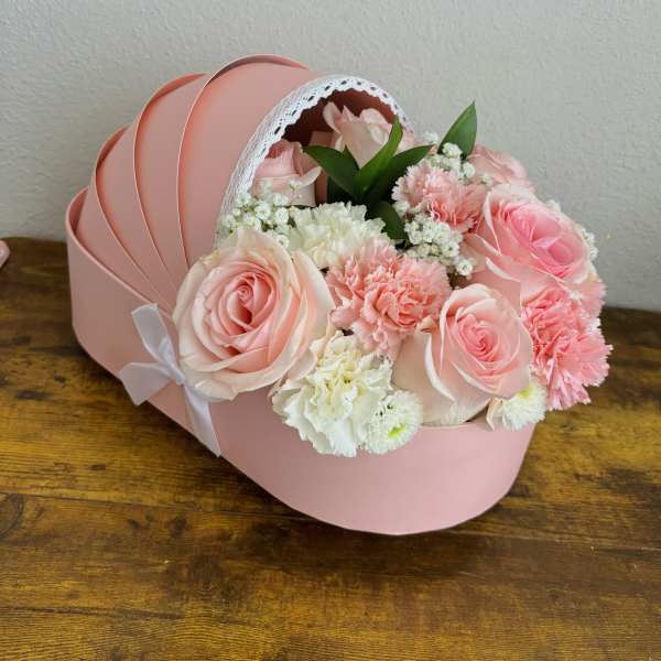 Pink rose and carnation bouquet in a round pink box