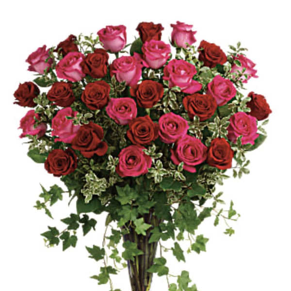 Bouquet of pink and red roses in a clear glass vase