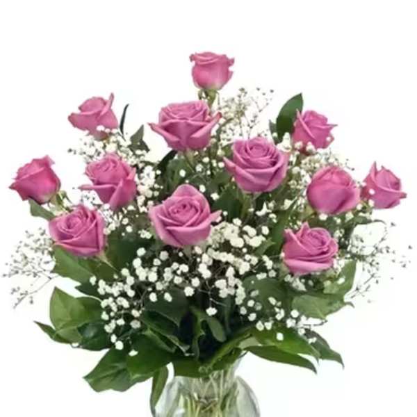 Pink roses in a glass vase with white baby's breath