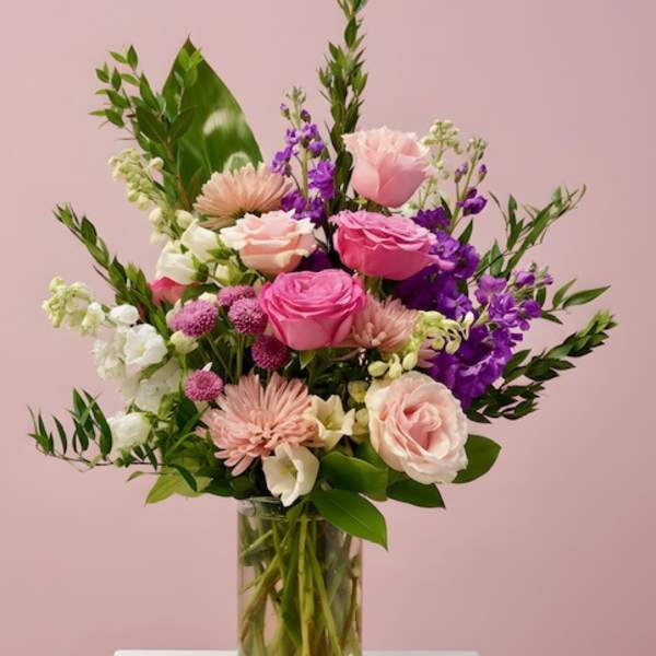 Pink and purple mixed bouquet in a clear glass vase