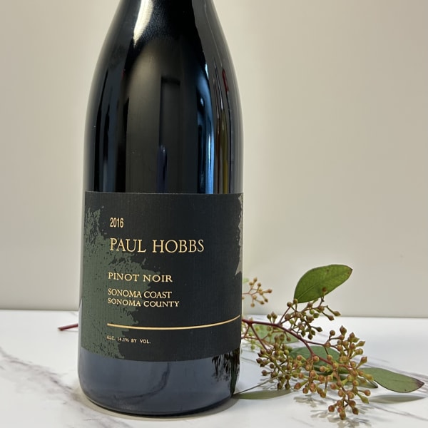 Bottle of Paul Hobbs Pinot Noir with a small sprig of greenery beside it