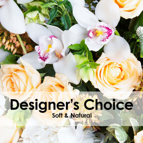 Soft cream roses and white orchids in a mixed bouquet