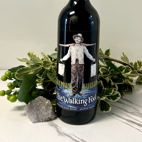 Wine bottle with variegated greenery and a crystal cluster