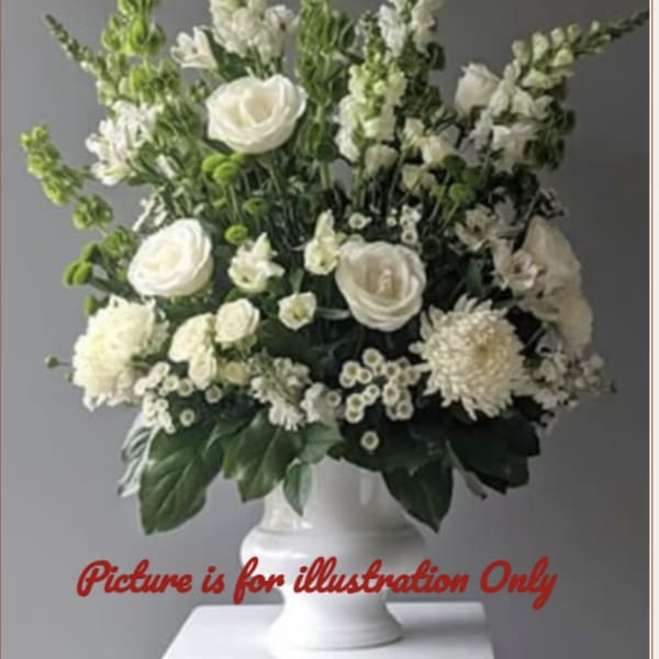 White floral arrangement in a pedestal vase