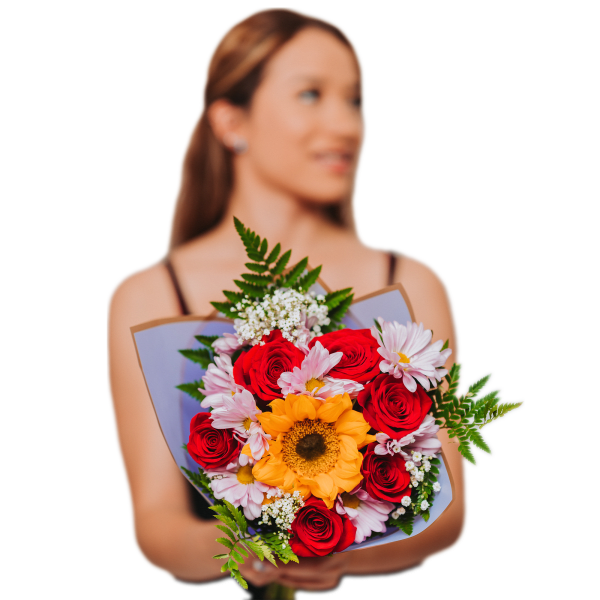 Woman holding a bouquet of red roses, a sunflower, and pale pink daisies