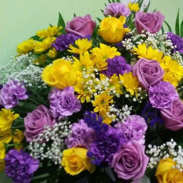 Bouquet of yellow and purple flowers with lavender roses