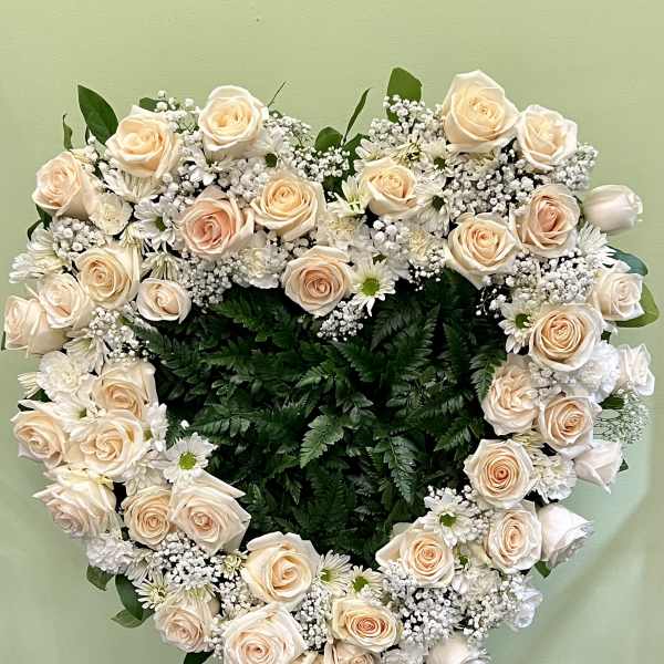 Heart-shaped floral wreath of cream roses and white filler flowers