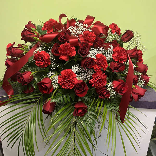 Large red rose and carnation arrangement with ribbon and baby's breath