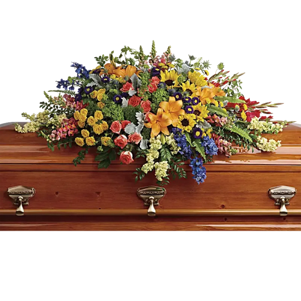 Colorful floral casket spray on a wooden coffin