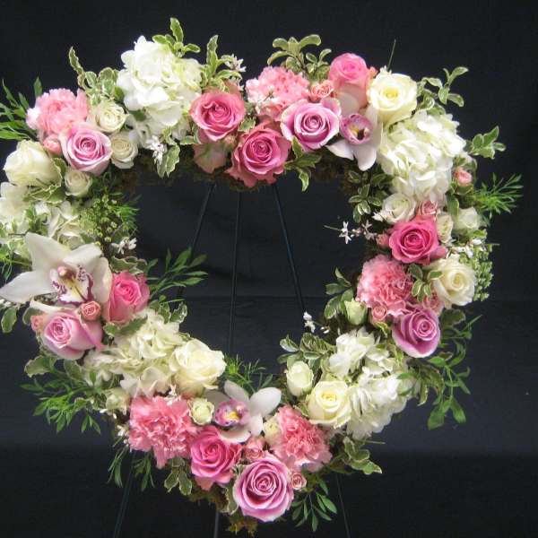 Heart-shaped floral wreath with pink and white roses and hydrangeas