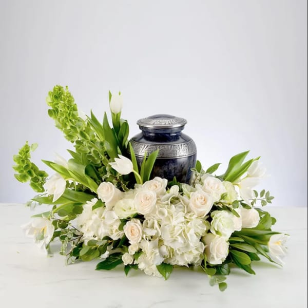 White floral arrangement with a dark urn centerpiece