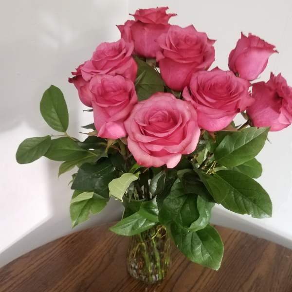 Pink roses in a clear glass vase