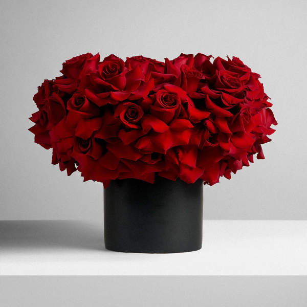 Red rose bouquet in a black cylindrical vase