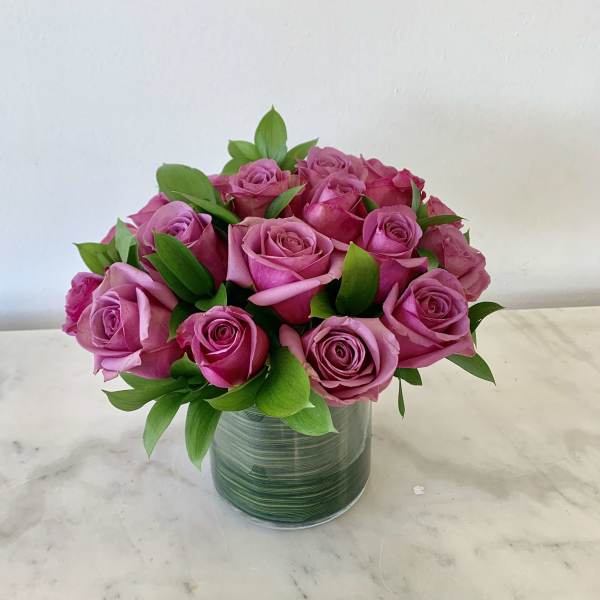 Pink roses arranged in a clear glass vase