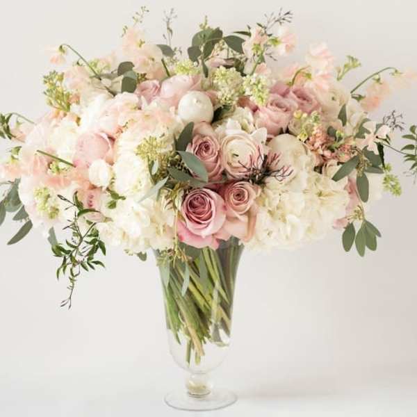 Blush and white bouquet in a clear glass vase