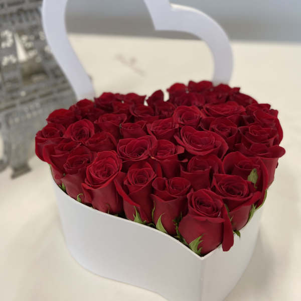 Heart-shaped box filled with red roses