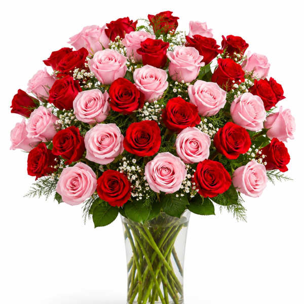 Bouquet of red and pink roses in a clear glass vase