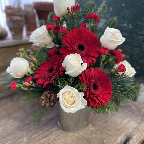 Red gerberas and white roses in a metal vase