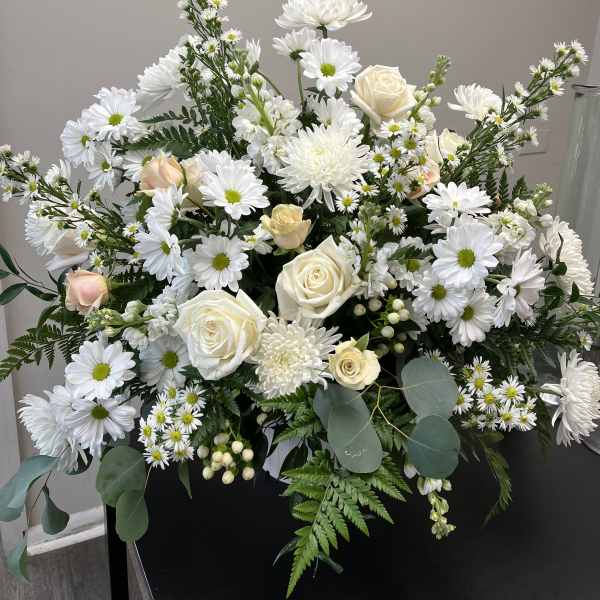 White daisies and cream roses arranged in a large bouquet