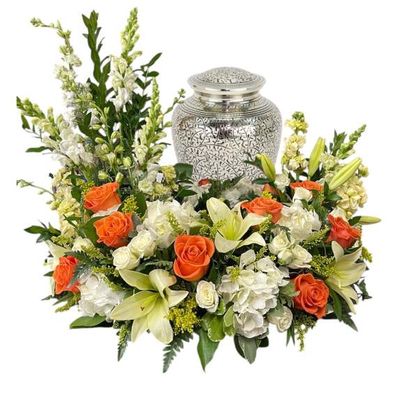 Floral funeral urn arrangement with orange roses and white lilies