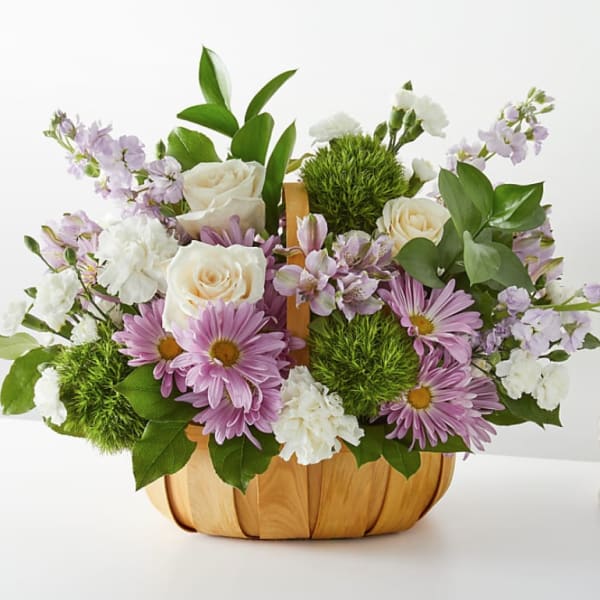 Lavender daisies and white roses in a wooden basket