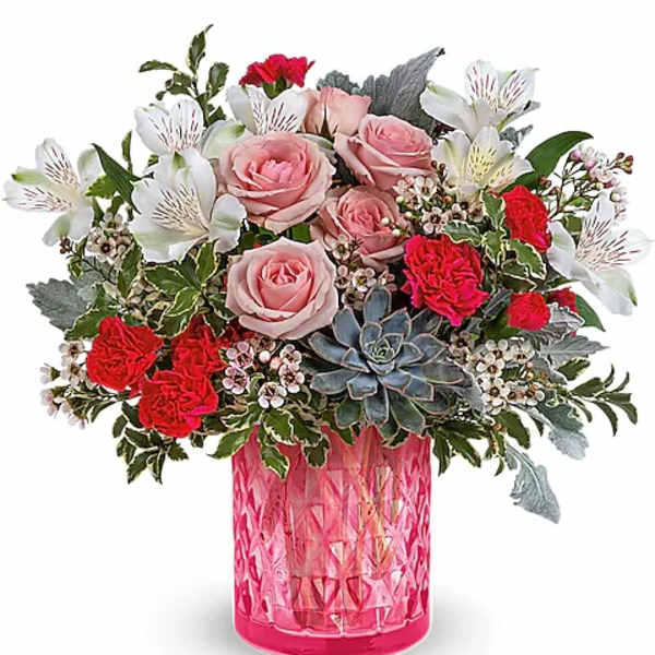 Pink and red flower arrangement in a bright pink vase