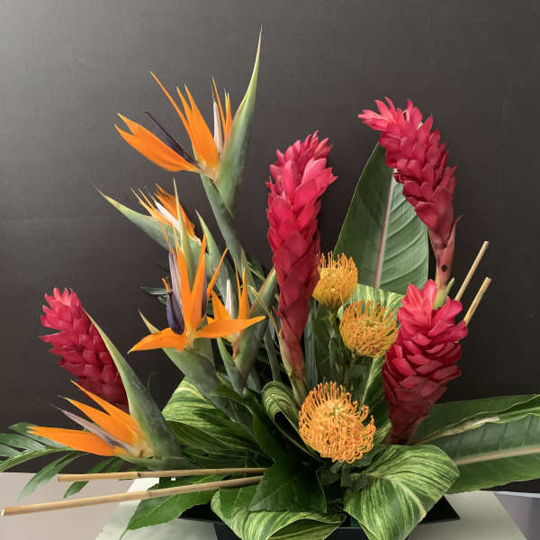 Tropical arrangement with orange bird-of-paradise and pink ginger flowers